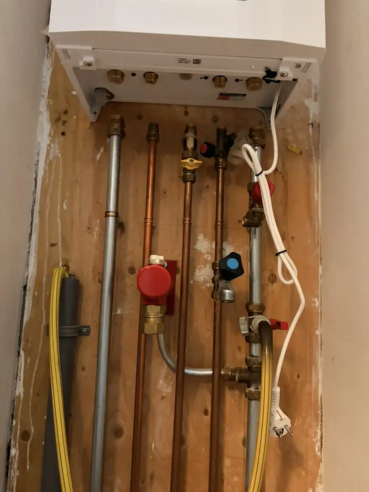 The connections under a newly fitted boiler